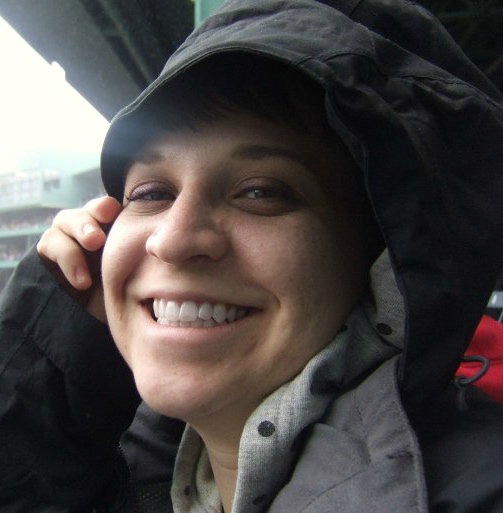 At a rainy Red Sox game, almost sitting on the Green Monster.